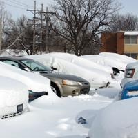 Autumn Gray/Collegian -  At the HCC dormitory parking lots, rows of cars were buried beneath a foot-deep blanket of snow. One car in this row had been dug out and driven.