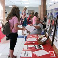 Paige Brier/Collegian - At the Health and Wellness Fair on Sept. 17, a student stops to get information at the Red Flag Campaign exhibit. The campaign strives to help young people see and deal with abusive “red flags” in their relationships.
