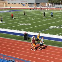 Tiara Brown/Collegian - Blue Dragon football players engage in drills on the soft, newly installed field turf at Gowans Stadium on April 1 as track athletes work out on the all-weather track. 