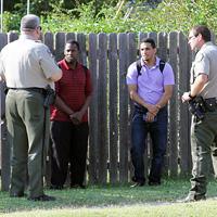 Hannah Wallace/Collegian -  Hutchinson police talk with two recruiters who had been on the HCC campus. A member of the group, minutes earlier, had posed as a student in a residence hall, then fled from an HCC security officer.