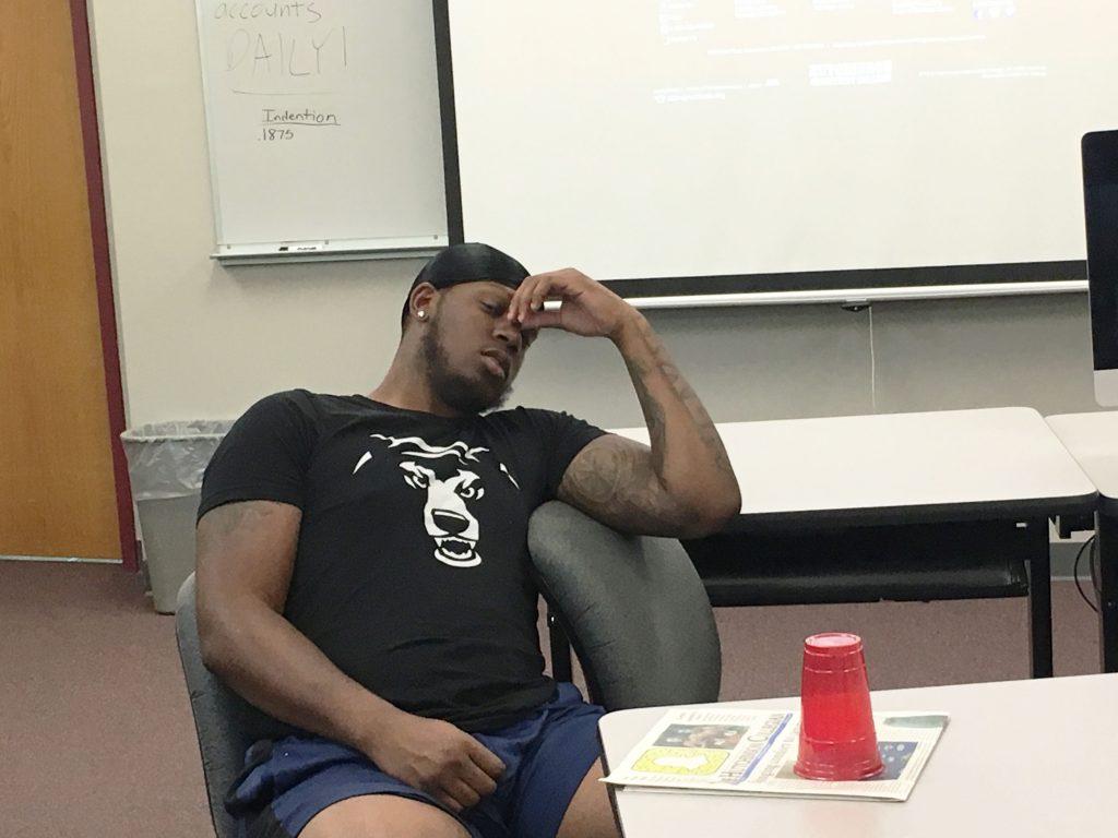 Justin Harris tries to stay in a group discussion during his 8 a.m. class, but he's not a fan of the early start time.