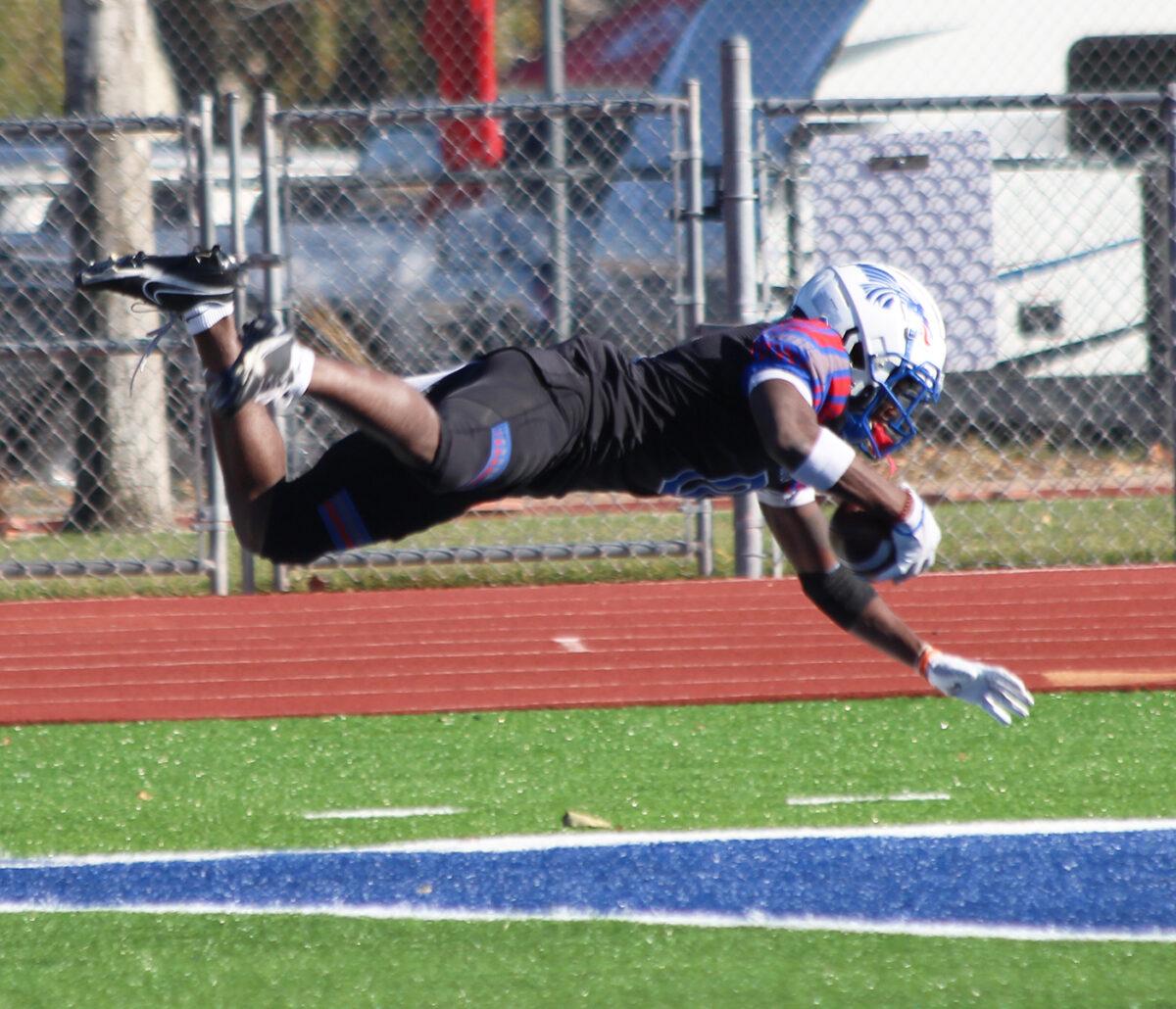 Hutchinson Community College's Oran Singleton Jr. stretches out to get into the end zone and score a touchdown on Nov. 11 at Gowans Stadium. The Blue Dragons beat Iowa Western 42-28. Photo by Grace Vallejo/Collegian