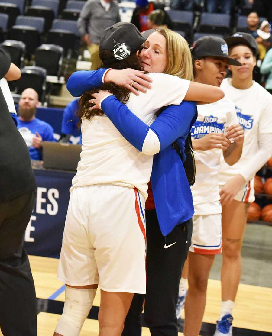 Celeste Ontjes (right) hugs Hutchinson Community College's Akaysha Muggeridge on Monday, April 1 at Ford Wyoming Center in Casper, Wyo., after the Blue Dragons won the NJCAA national championship. Ontjes' husband is HutchCC coach John Ontjes.
