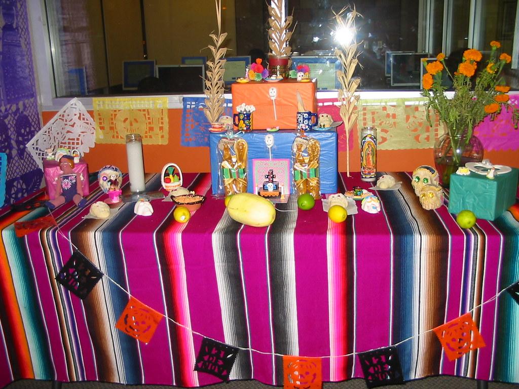 "Day of the Dead Altar/ Altar de Dia de los Muertos" by San José Public Library is licensed under CC BY-SA 2.0. To view a copy of this license, visit https://creativecommons.org/licenses/by-sa/2.0/?ref=openverse.