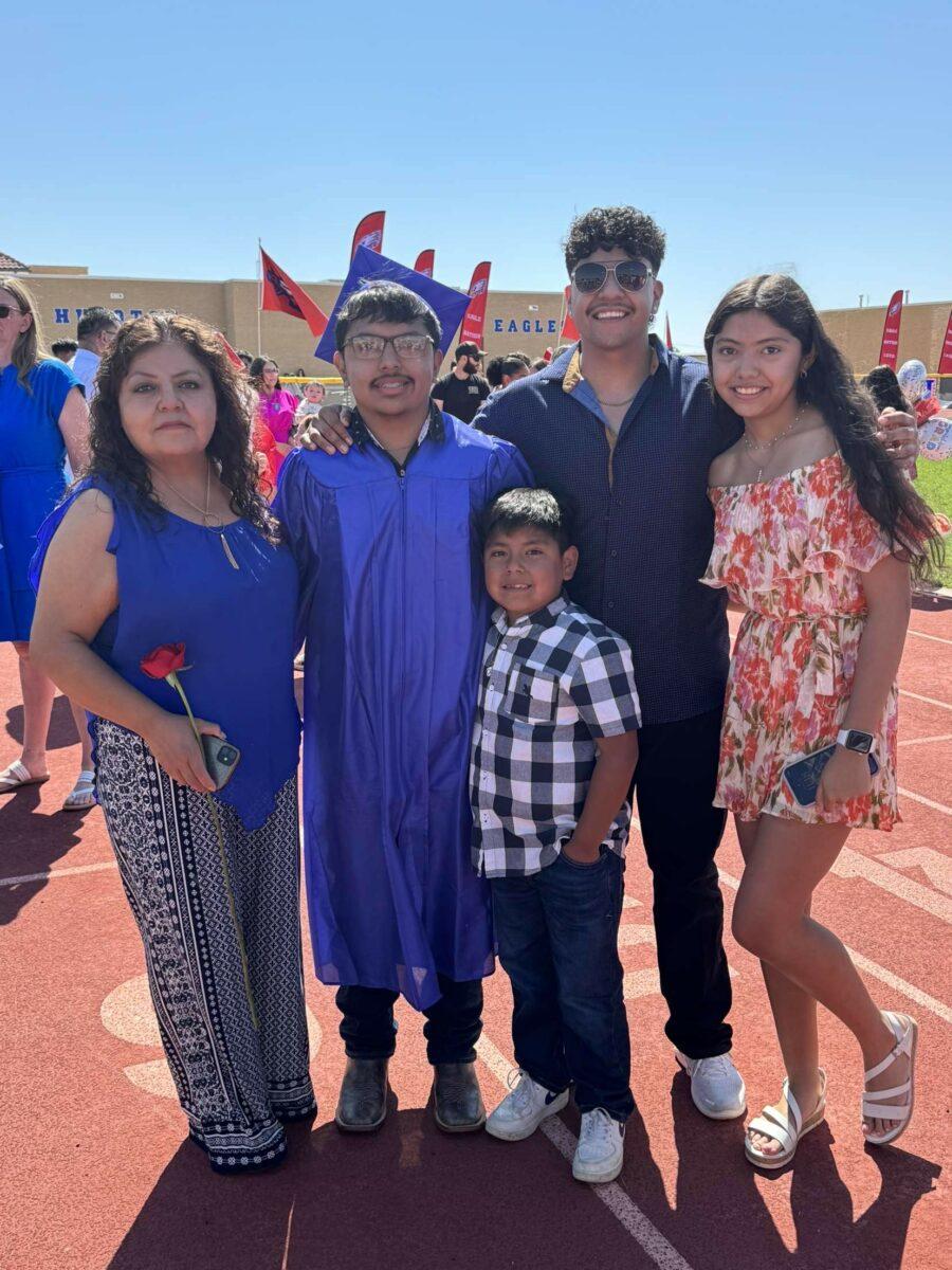 Daniel Gonzalez (in cap and gown), a Hugoton freshman, poses with family during his high school graduation in May.