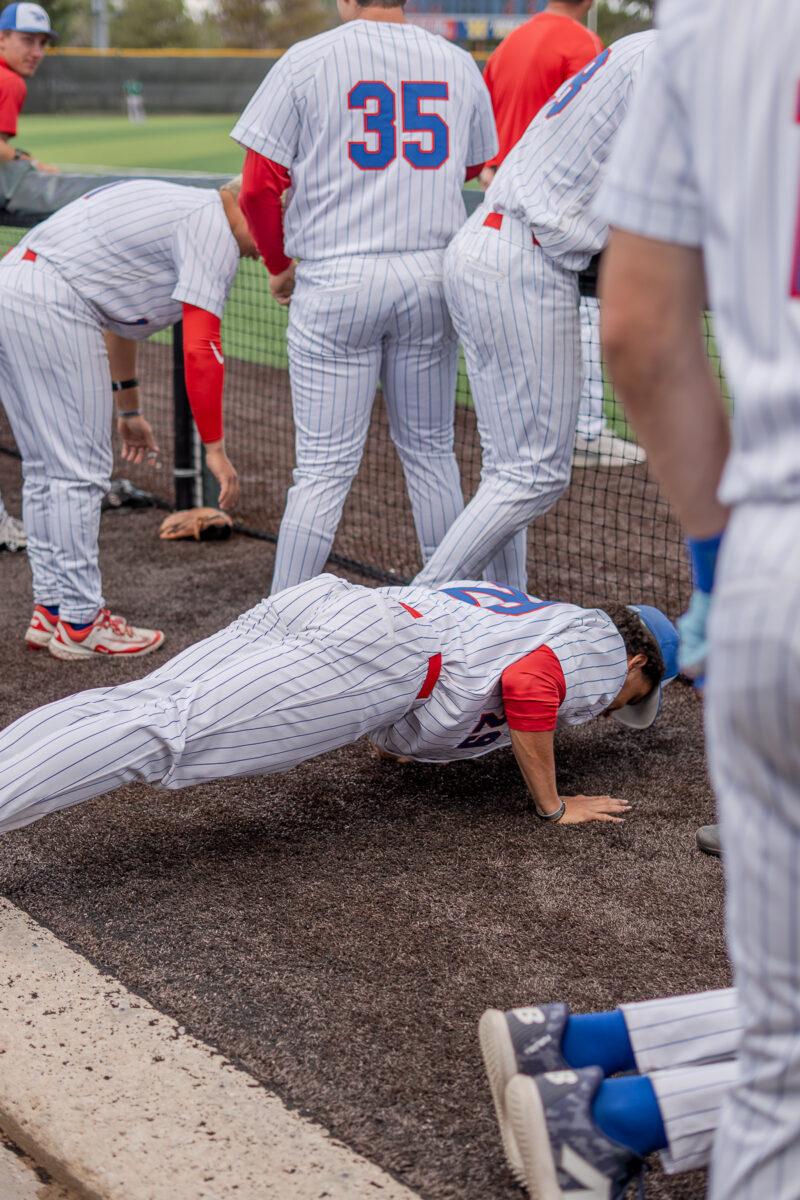 Reece Usselman does some push-ups in the dugout during Hutchinson Community College's baseball games on April 18 at Hobart-Detter Field.