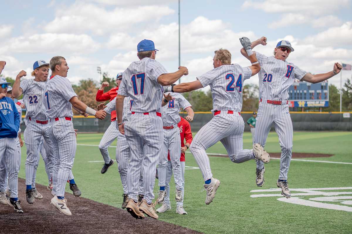 Jordan Kuhnau (24) and Austin Crawford (24) celebrate a Kuhnau home run hit at Hobart-Detter Field on April 18 against Seward County.