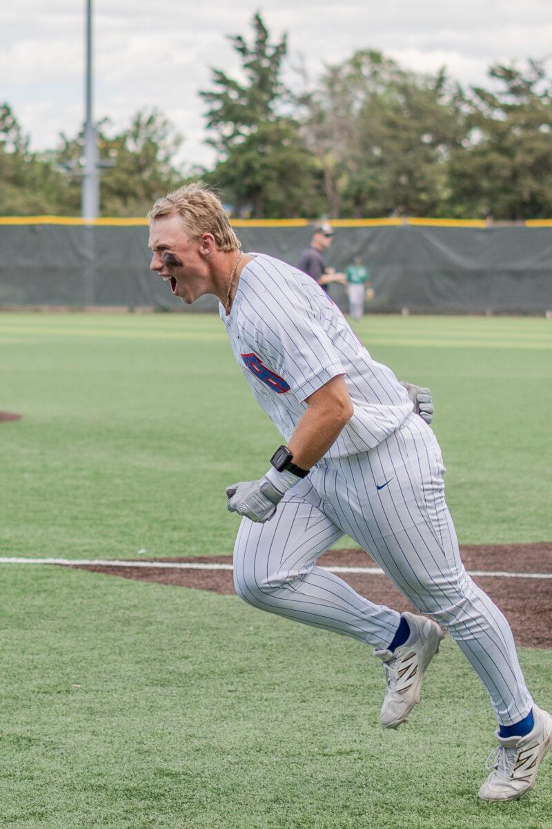 Hutchinson Community College baseball player Jordan Kuhnau celebrates after scoring a run against Seward County on April 18 at Hobart-Detter Field.