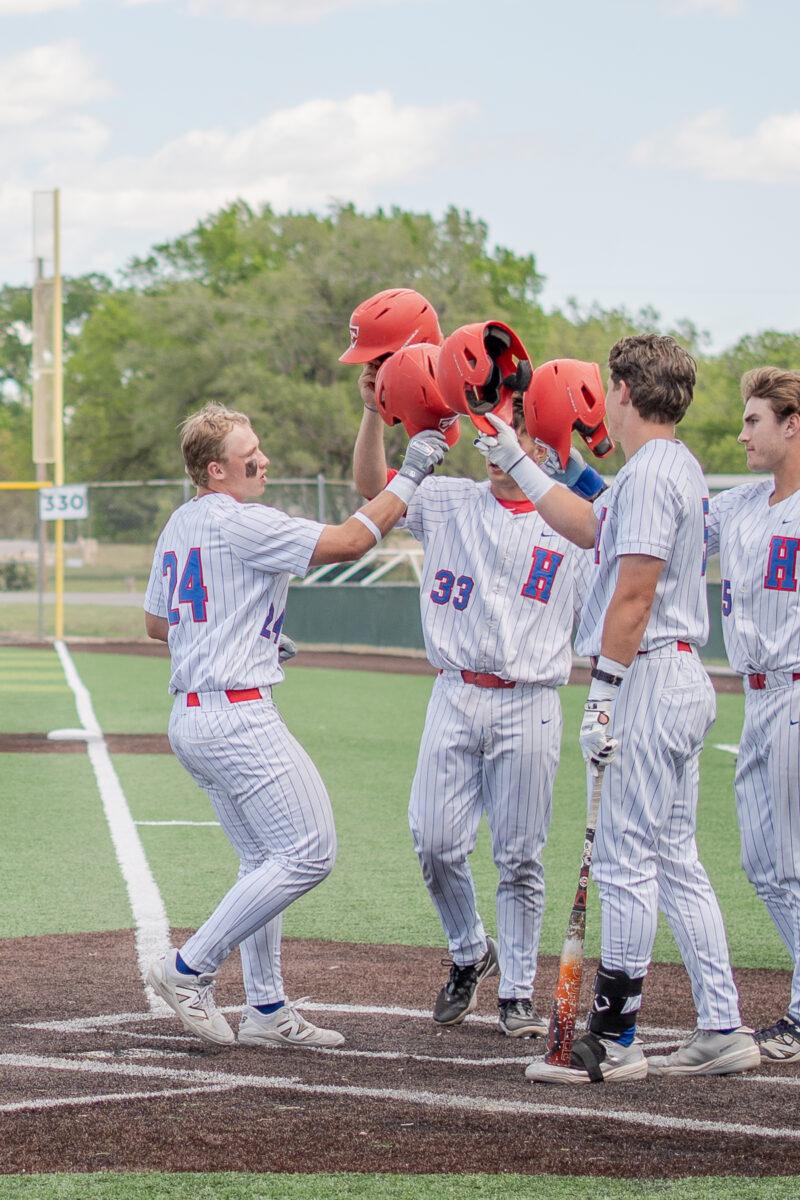 Hutchinson Community College's Jordan Kuhnau (24) celebrates at home plate with teammates during a game April 18 against Seward County at Hobart-Detter Field