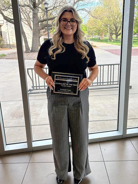The Hutchinson Collegian Editor in Chief Lizzie Rush poses with the plaque presented to her on April 12 at Wichita State for winning the Kansas Collegiate Media's Two-Year College Journalist of the Year award.